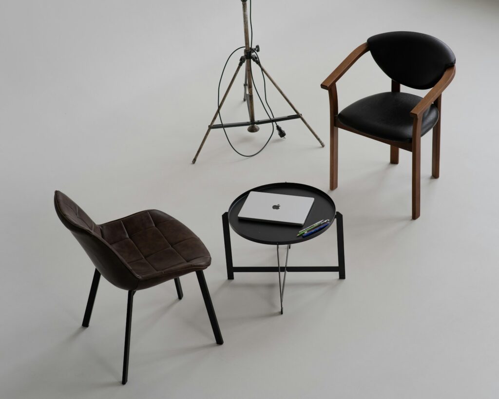 Photo by Eugene Chystiakov three chairs and a table with a laptop on it