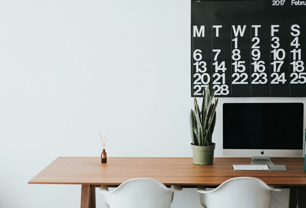 Photo by Roman Bozhko silver iMac on brown wooden desk
